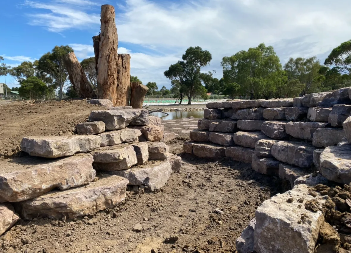 Stone retaining wall in a natural landscape.