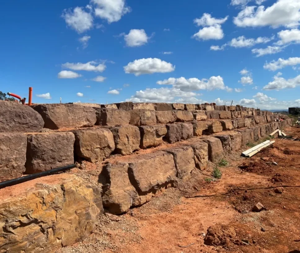 Stone retaining wall construction with blue sky