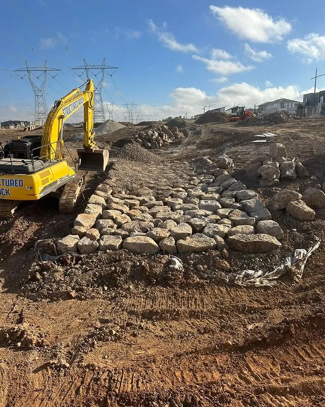 Excavator working on rocky construction site