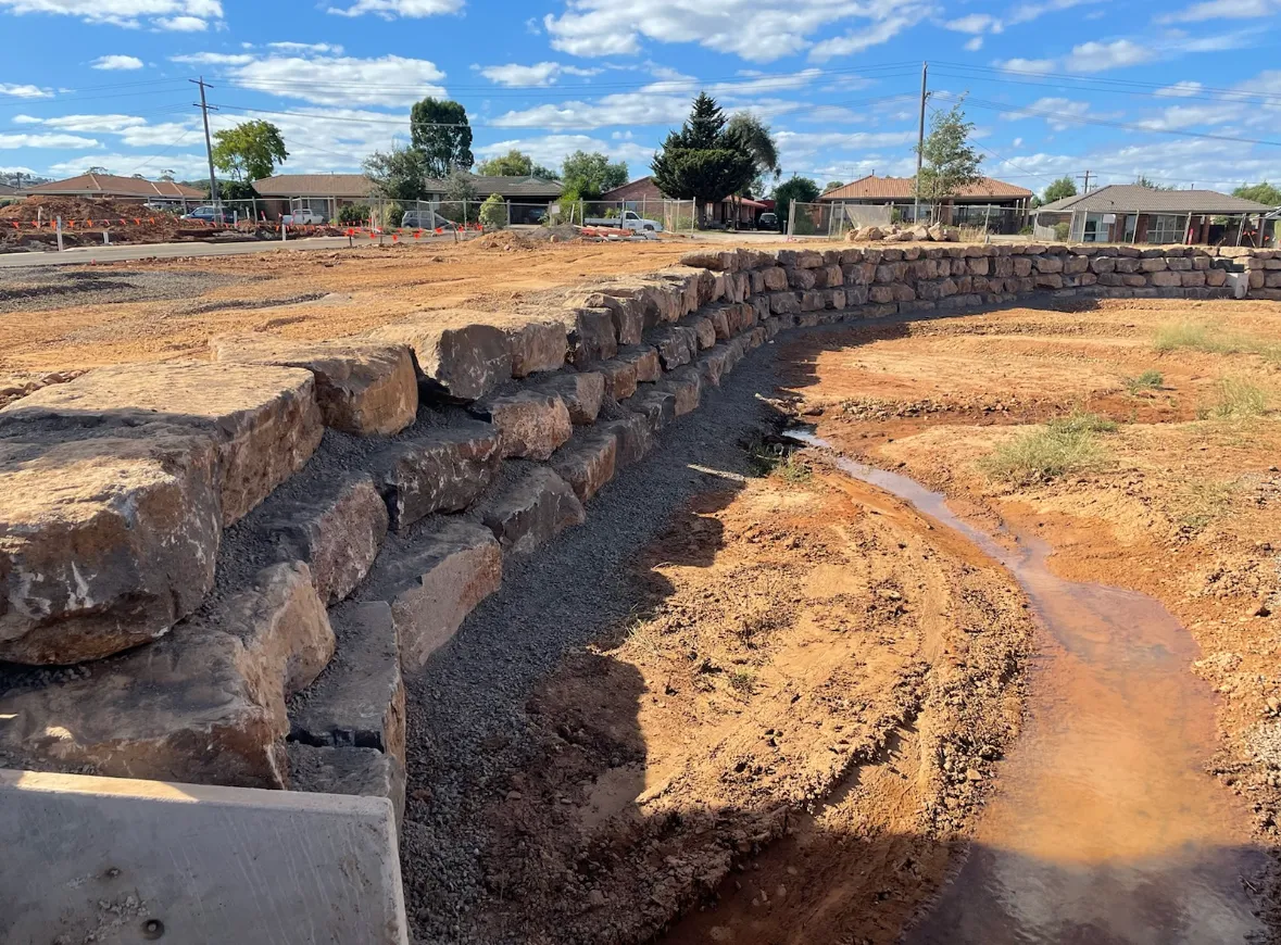 Retaining wall with drainage in rural construction site.
